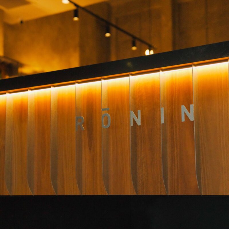 Rōnin name cut into the backlit timber bar front